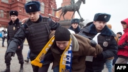 Police officers detain a protester in central Manezhnaya Square in Moscow, on March 2, 2014, during an unsanctioned rally against the Russia's military actions in Crimea. 