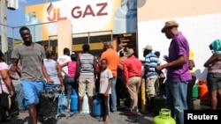 People gather while waiting to buy gas in Port-au-Prince, Haiti, Feb. 16, 2019. 