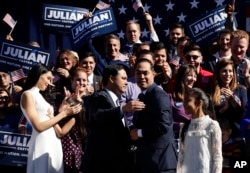 Former San Antonio Mayor and Housing and Urban Development Secretary Julian Castro, center right, is embraced by his twin brother, U.S. Rep. Joaquin Castro (D-San Antonio), center left, during an event where Julian Castro announced his decision to seek the Democratic nomination for president in 2020.