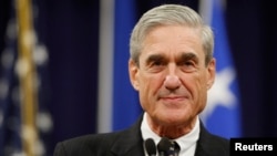 FILE - Then-FBI Director Robert Mueller pauses during his remarks at the Justice Department in Washington, Aug. 1, 2013.