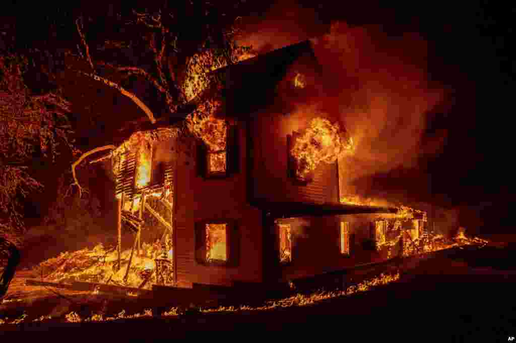 A home burns on Jeters Road as the Dixie fire jumps Highway 395 south of Janesville, California, Aug. 16, 2021.