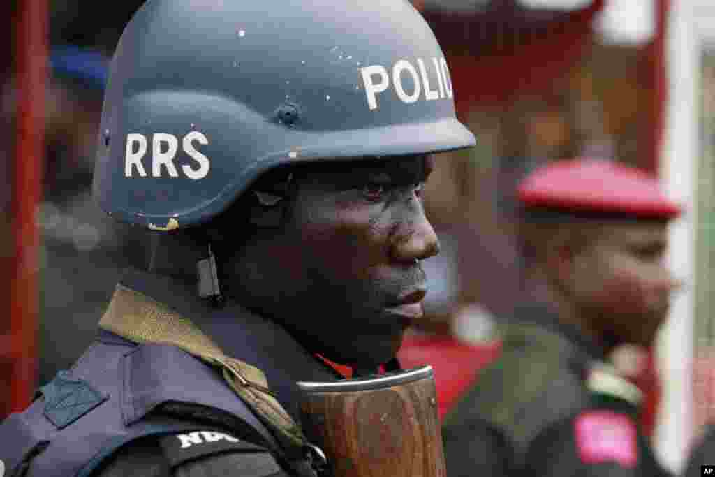 A police officer stand guards during a demonstration calling on the government to rescue the kidnapped school girls from a government secondary school Chibok, May, 1. 2014.