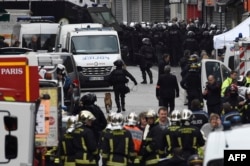 Firefighters and police are gathered in the northern Paris suburb of Saint-Denis on Nov. 18, 2015, as special forces raid an appartment, hunting those behind the attacks that killed 129 in the French capital last week.
