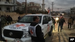 FILE - The International Committee of the Red Cross, working alongside the Syrian Arab Red Crescent (SARC) and the United Nations, shows a convoy containing food, medical items, blankets and other materials being delivered to the town of Madaya in Syria, Jan. 11, 2016