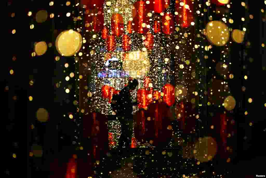 A man walks past Chinese Lunar New Year lanterns at a shopping mall in Jakarta, Indonesia.