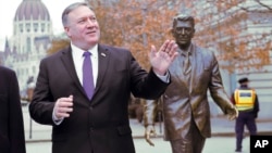US Secretary of State, Mike Pompeo, is pictured next to a scuplture of former US President Ronald Reagan at the Liberty square (Szabadsag) in Budapest, Hungary, Feb. 11, 2019. 