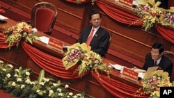 Politburo member Truong Tan Sang, right, reads a document while Vietnamese Prime Minister Nguyen Tan Dung looks on at the opening ceremony of the 11th National Congress of the Vietnamese Communist Party in Hanoi, Vietnam on January 12, 2011