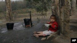 A boy holds a bowl of rice in a refugee camp in Laiza, the area controlled by the Kachin in northern Burma, February 12, 2012.