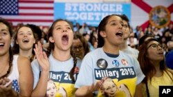 Members of the audience cheer as Democratic presidential candidate Hillary Clinton speaks at a rally at Palm Beach State College in Lake Worth, Florida, Oct. 26, 2016.