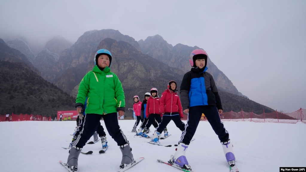 School children learning to ski take to the hills at the Vanke Shijinglong Ski Resort in Yanqing outside of Beijing, China on December. 23, 2021. (AP Photo/Ng Han Guan)