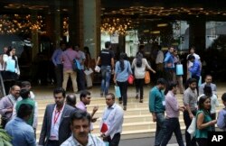 FILE - Visitors crowd at the Global Mobile Internet Conference in Bangalore, India, Sept. 10, 2015.