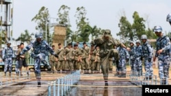 FILE - Chinese and Russian soldiers take part in a joint military drill in Zhanjiang, Guangdong province, China, Sept. 13, 2016. 