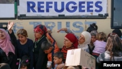 People queue to receive free food at a makeshift camp for migrants and refugees at the Greek-Macedonian border near the village of Idomeni, Greece, April 6, 2016.