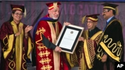 Afghan President Hamid Karzai receives an honorary degree from his Indian counterpart Pranab Mukherjee, second right, at the Lovely Professional University in Jalandhar, India, May 20, 2013.