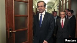 Newly appointed Greek Prime Minister Antonis Samaras arrives for the first cabinet meeting of his government at the parliament in Athens, June 21, 2012.