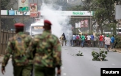 FILE - Supporters of Kenya's opposition Coalition for Reforms and Democracy (CORD) run after riot police fired tear gas before their "Saba Saba Day" rally in July 2014 in Nairobi.