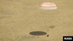 The Soyuz TMA-03M spacecraft lands with three members of Expedition 31 from the International Space Station in a remote area near the town of Zhezkazgan, Kazakhstan, July 1, 2012.