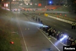 Police are seen as people gather on Interstate 94 to protest the fatal shooting of Philando Castile by Minneapolis area police during a traffic stop, in St. Paul, Minnesota, July 9, 2016.