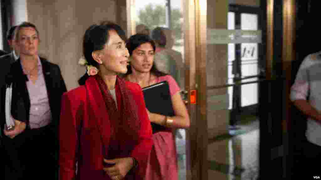 Aung San Suu Kyi smiles as she enters VOA headquarters during her first visit to the U.S. since being released from nearly two decades of house arrest.