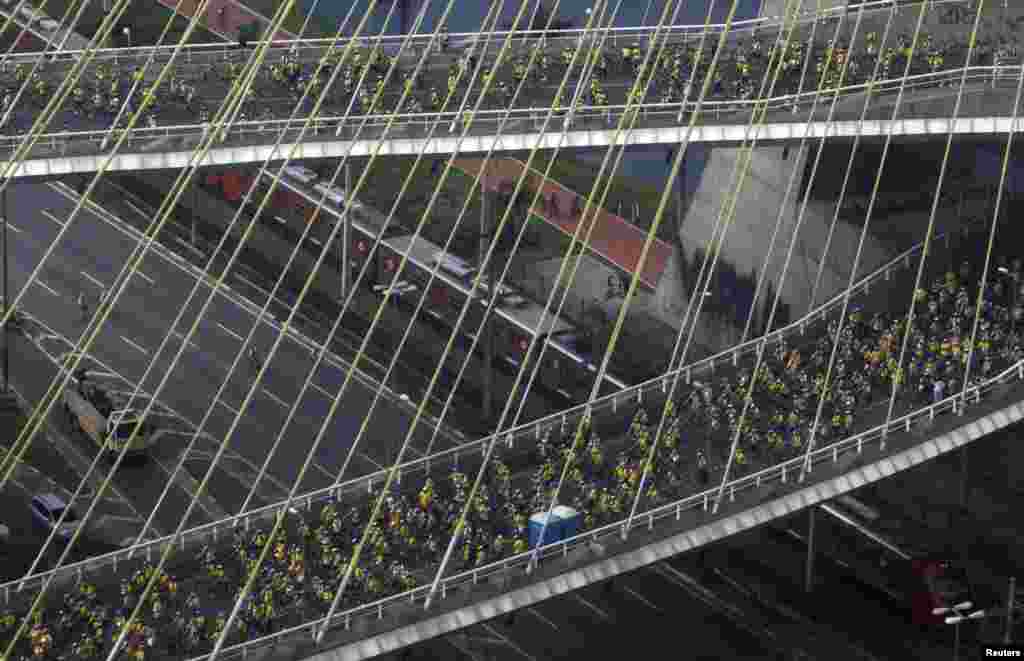 Cyclists are seen on the Octavio Frias de Oliveira Bridge as they participate in the World Bike Tour in Sao Paulo, Brazil. The event involves 8,000 people that will ride their bicycles for a better quality of life, according to the organizers.