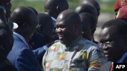 FILE - South Sudan rebel leader and former first vice president Riek Machar (C) is seen with supporters at Juba international airport, April 26, 2016. Having received medical treatment in the DRC, he is now in the Sudanese capital, Khartoum.