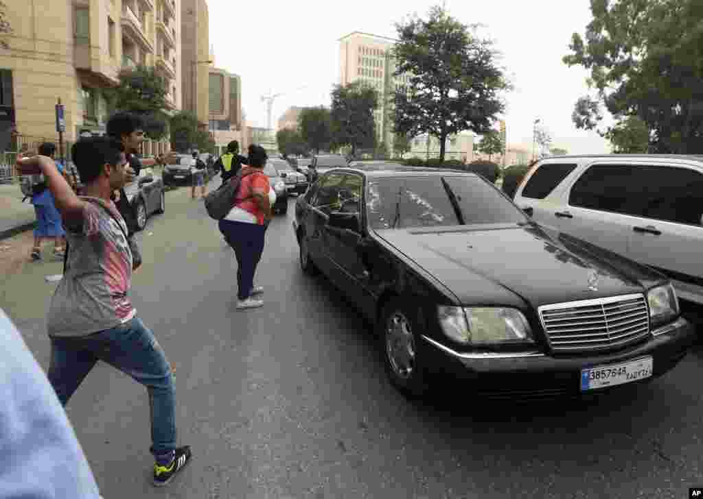 Lebanese anti-government protesters throw eggs and water bottles at the unknown convoy of a politician leaving the parliament building during a protest against the ongoing trash crisis and government corruption in downtown Beirut. &nbsp;