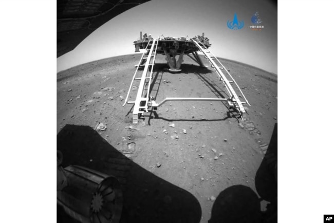 In this image released by the China National Space Administration (CNSA) on Saturday, May 22, 2021, a landing platform and the surface of Mars are seen from a camera on the Chinese Mars rover Zhurong. CNSA via AP)