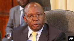  FILE - Kenya's Attorney General Githu Muigai speaks to journalists in Nairobi, Kenya, January 2012.