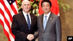 U.S. Vice President Mike Pence, left, shakes hands with Japan's Prime Minister Shinzo Abe upon his arrival at the prime minister's official residence in Tokyo Wednesday, Feb. 7, 2018.