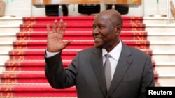 Ivory Coast Prime Minister Daniel Kablan Duncan waves after the resignation of his government in the Presidential Palace in Abidjan, Ivory Coast, Jan. 9, 2017. President Alassane Ouattara has named him vice president, a new post created under a constitution approved by referendum late last year.