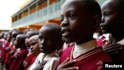 FILE - Students sing during morning assembly at Kyamusansala Primary School in Masaka, Uganda, March 24, 2009. 