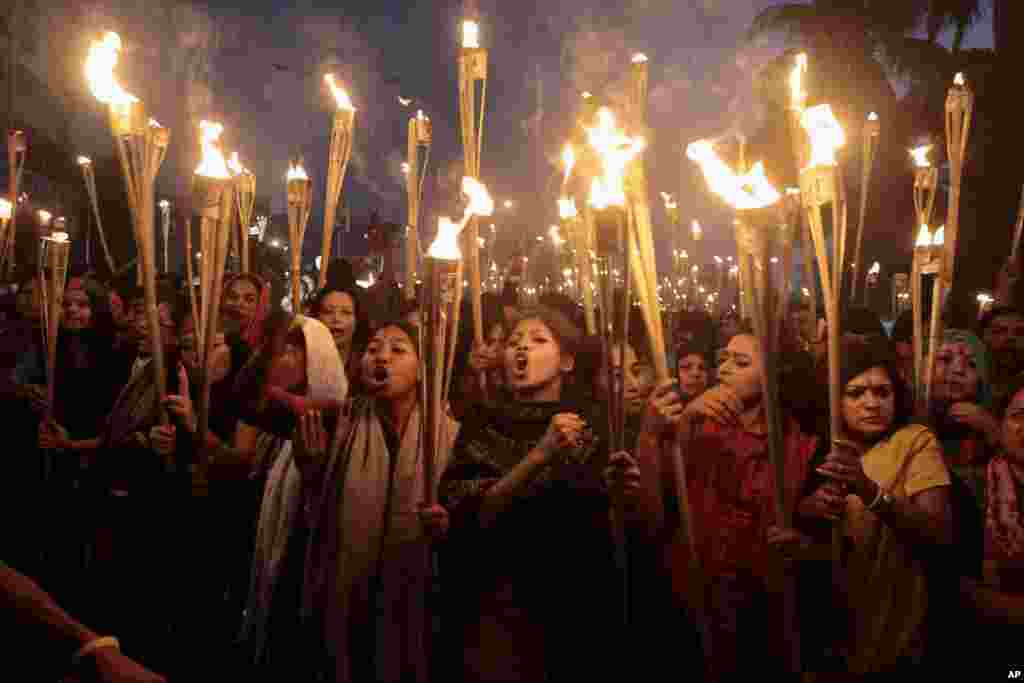 Activists shout slogans as they participate in a rally in Dhaka, Dec. 12, 2013. 