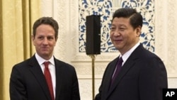 U.S. Treasury Secretary Timothy Geithner, left, shakes hands with Chinese Vice President Xi Jinping at the Great Hall of the People in Beijing, January 11, 2012