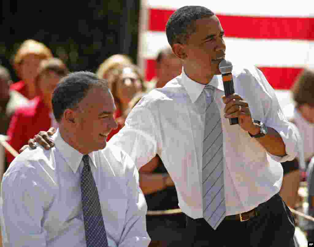 Then-Democratic Presidential nominee, Sen. Barack Obama, D-Ill., right, puts his arm around then-Virginia Gov. Tim. Kaine during a town hall meeting in Chester, Virginia, Aug. 21, 2008.