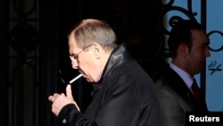 Sergey Lavrov lights a cigarette outside the Montreuz Palace Hotel in Geneva, Jan. 22, 2014.