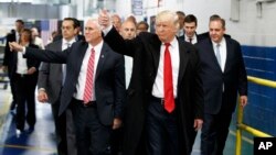 President-elect Donald Trump and Vice President-elect Mike Pence wave as they visit to Carrier factory, Dec. 1, 2016, in Indianapolis, Ind. 