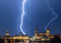 Lightning strikes across the sky in Dresden, Germany, Monday, June 10, 2019. (Robert Michael/dpa via AP)