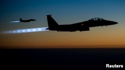 FILE - A pair of U.S. Air Force F-15E Strike Eagles fly over northern Iraq after conducting airstrikes in Syria, in this U.S. Air Force handout photo.