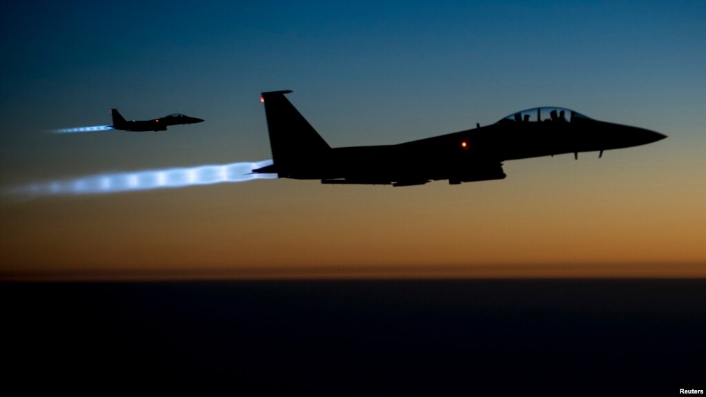 FILE - A pair of U.S. Air Force F-15E Strike Eagles fly over northern Iraq after conducting airstrikes in Syria, in this U.S. Air Force handout photo.