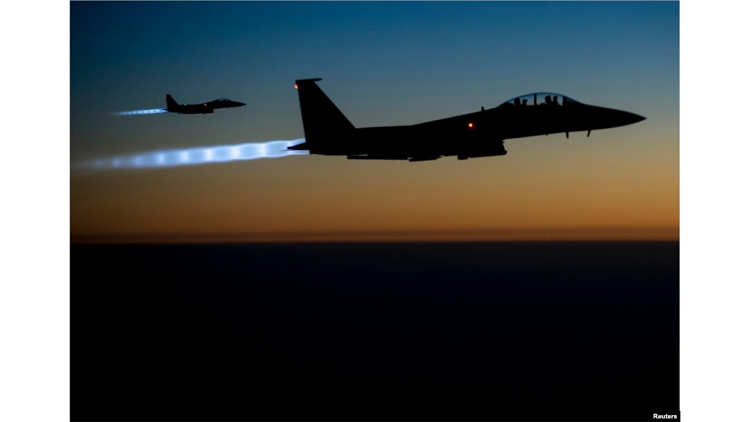 FILE - A pair of U.S. Air Force F-15E Strike Eagles fly over northern Iraq after conducting airstrikes in Syria, in this U.S. Air Force handout photo.