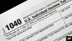 FILE - A Jan. 10, 2017, photo shows a 1040 U.S. Individual Income Tax Return form.