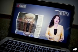 FILE - An online video about U.S.-China trade tensions produced by China's state television broadcaster plays on a computer screen in Beijing, China, Aug. 23, 2018.