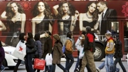 Shoppers walk in front of a bus with a huge clothing advertisement on Black Friday. The Friday after the Thanksgiving holiday is one of the biggest shopping days of the year