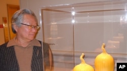 Ceramic artist Cliff Lee - pictured with his porcelain 'Prickly Melon' featuring his signature yellow glaze - combines his background as a neurosurgeon with his passion for clay to create exquisite objects inspired by his Chinese heritage.