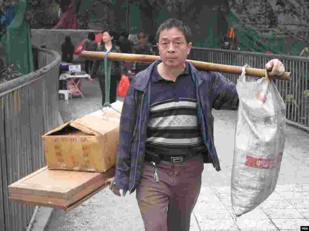 A farmer in Chongqing, formerly a part of Sichuan Province. In 1997 the city rose to be one of the four special municipalities under the direct control of the central government. The municipality encompasses large urban and rural areas in southwest China. (VOA/Ming Zhang)