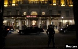 An Austrian police officer stands outside Hotel Imperial in Vienna, site of talks on the Syrian crisis, Nov. 13, 2015.