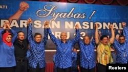 Malaysia's Prime Minister Najib Razak celebrates after winning the elections at his party headquarters in Kuala Lumpur, Malaysia, early May 6, 2013. 