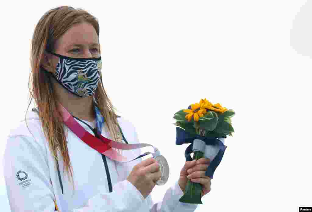 Silver medallist, Bianca Buitendag of South Africa wearing a protective face mask poses on the podium after winning the medal in women&#39;s shortboard. REUTERS/Lisi Niesner