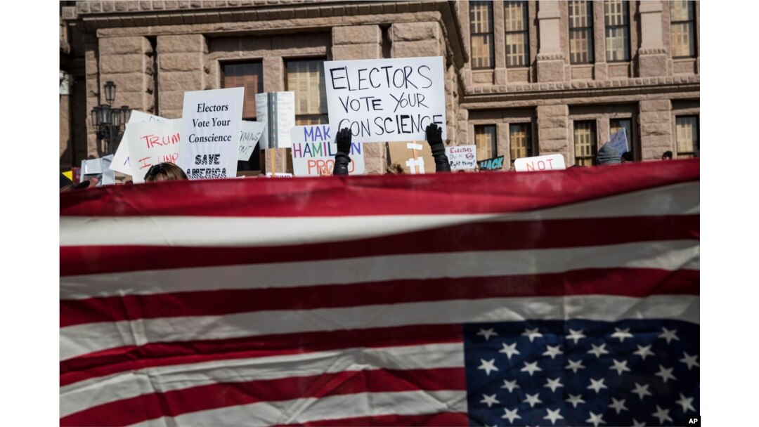 FILE - Demonstrators gather outside the Texas State Capitol in an attempt to influence the Republican electors from across the state to not vote for Donald Trump when they cast their formal ballots for president of the United States in Austin, Texas, Dec. 19, 2016.