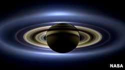 On July 19, 2013, NASA's Cassini spacecraft slipped into Saturn's shadow and turned to image the planet, seven of its moons, its inner rings -- and, in the background, our home planet, Earth. 